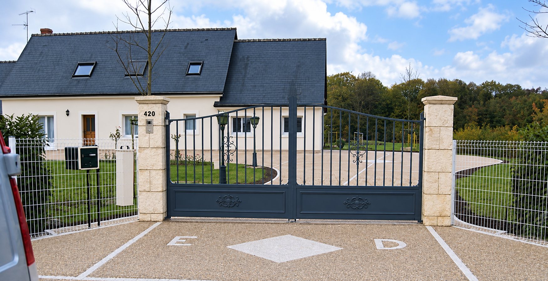 Allée en béton désactivé devant un portail et une maison